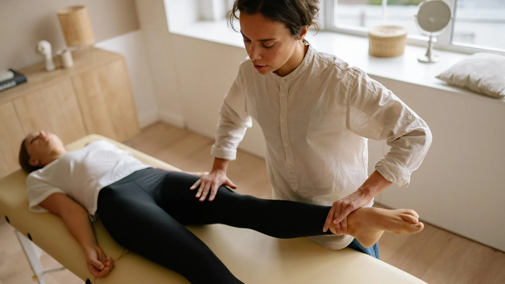 A practitioner supporting a patient